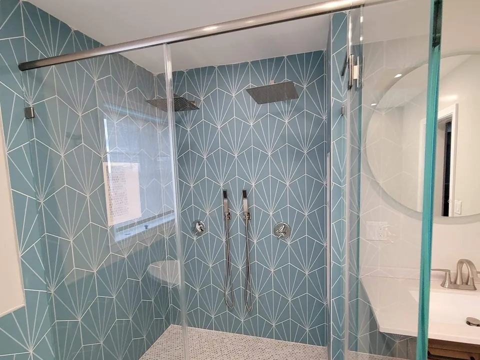 Glass shower and teal diamond tile bath