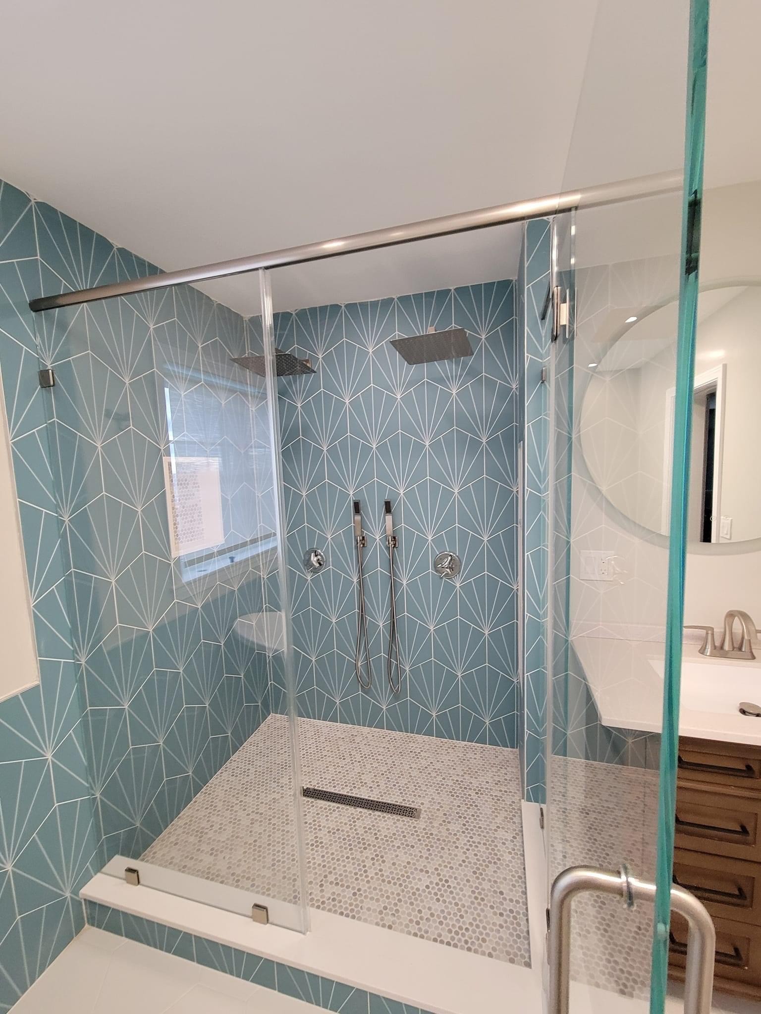 Glass shower and teal diamond tile bath