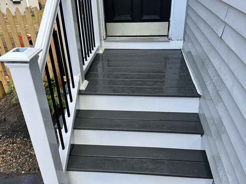 Composite entry steps with white railing and black balusters