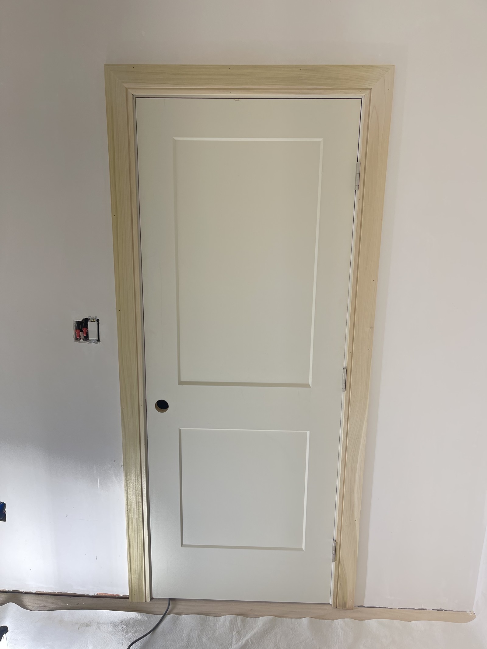 Painted two-panel interior door in a clear-finished jamb