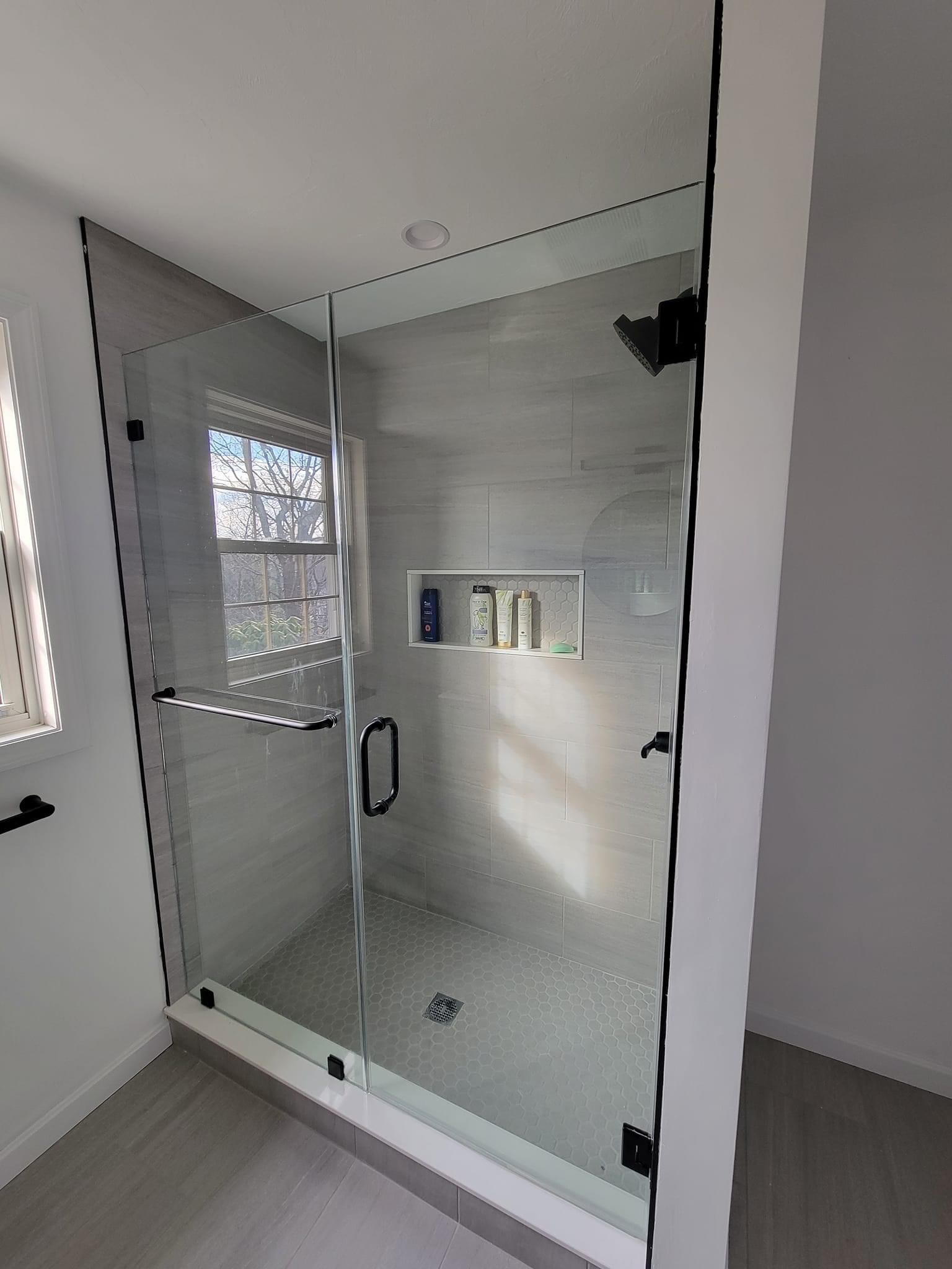 Glass shower with gray plank-look tile, Reading