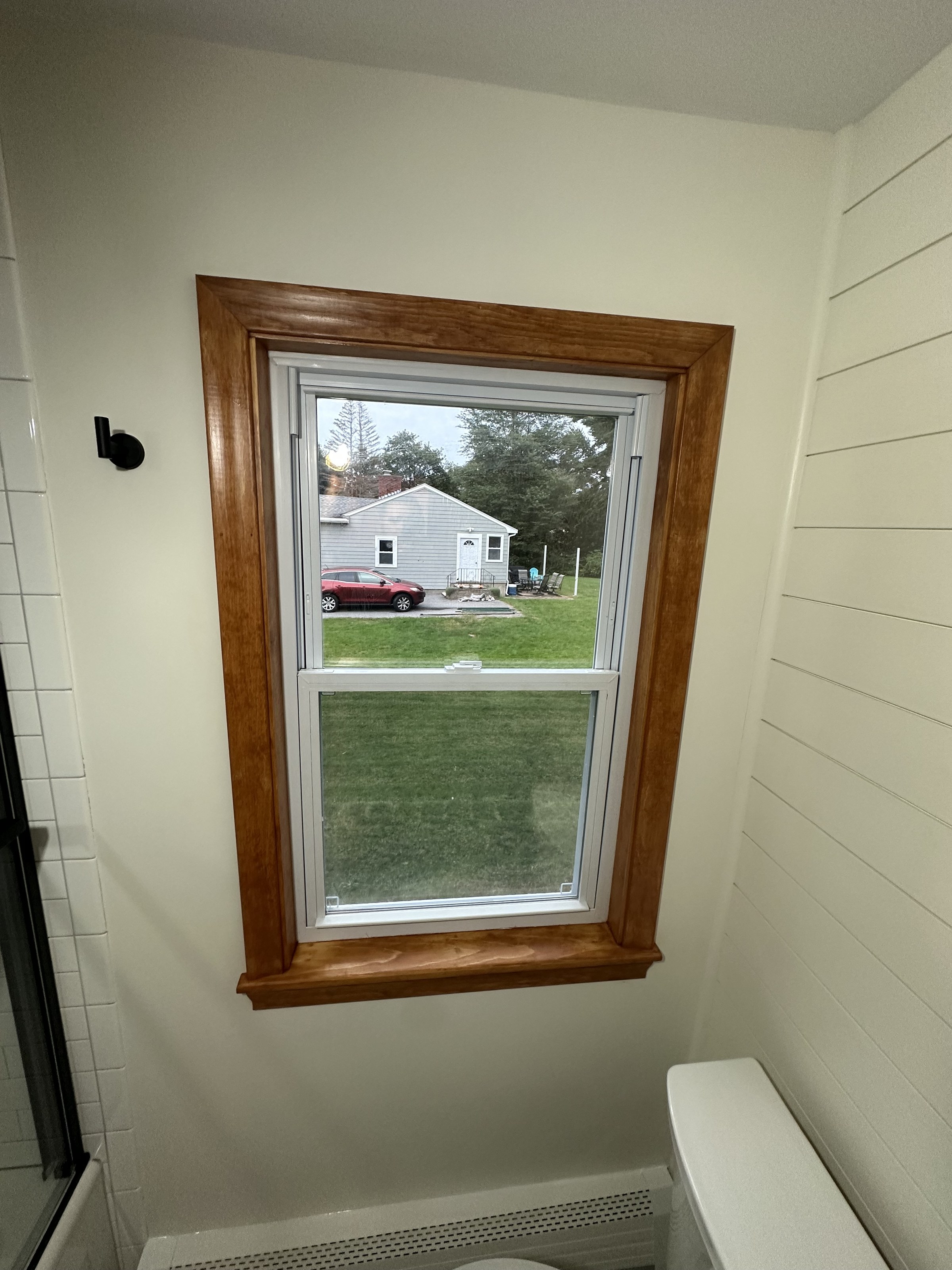 Stained wood window trim detail in a bathroom, North Reading