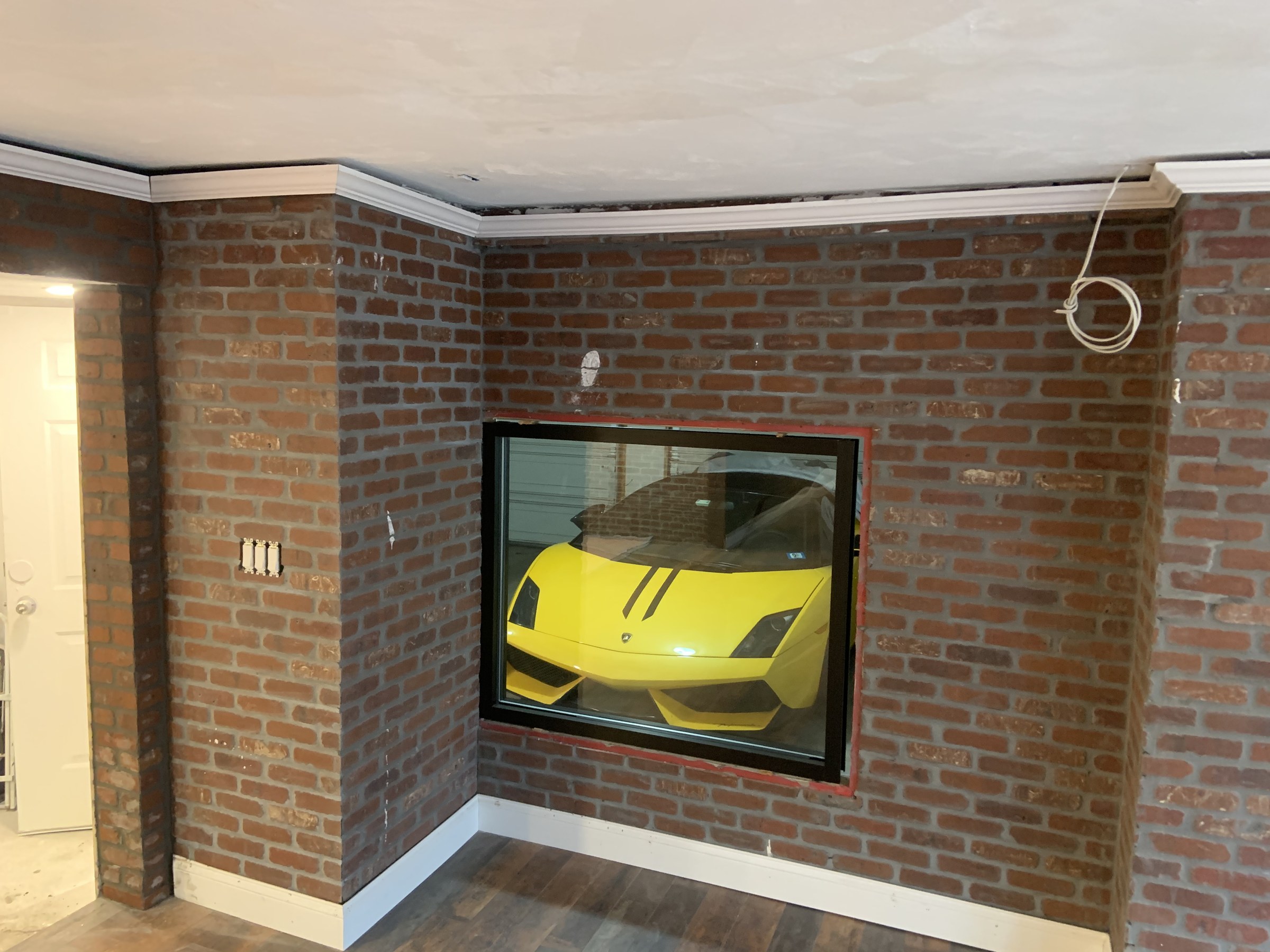 Detail of the brick accent wall with a glazed window feature cut through it