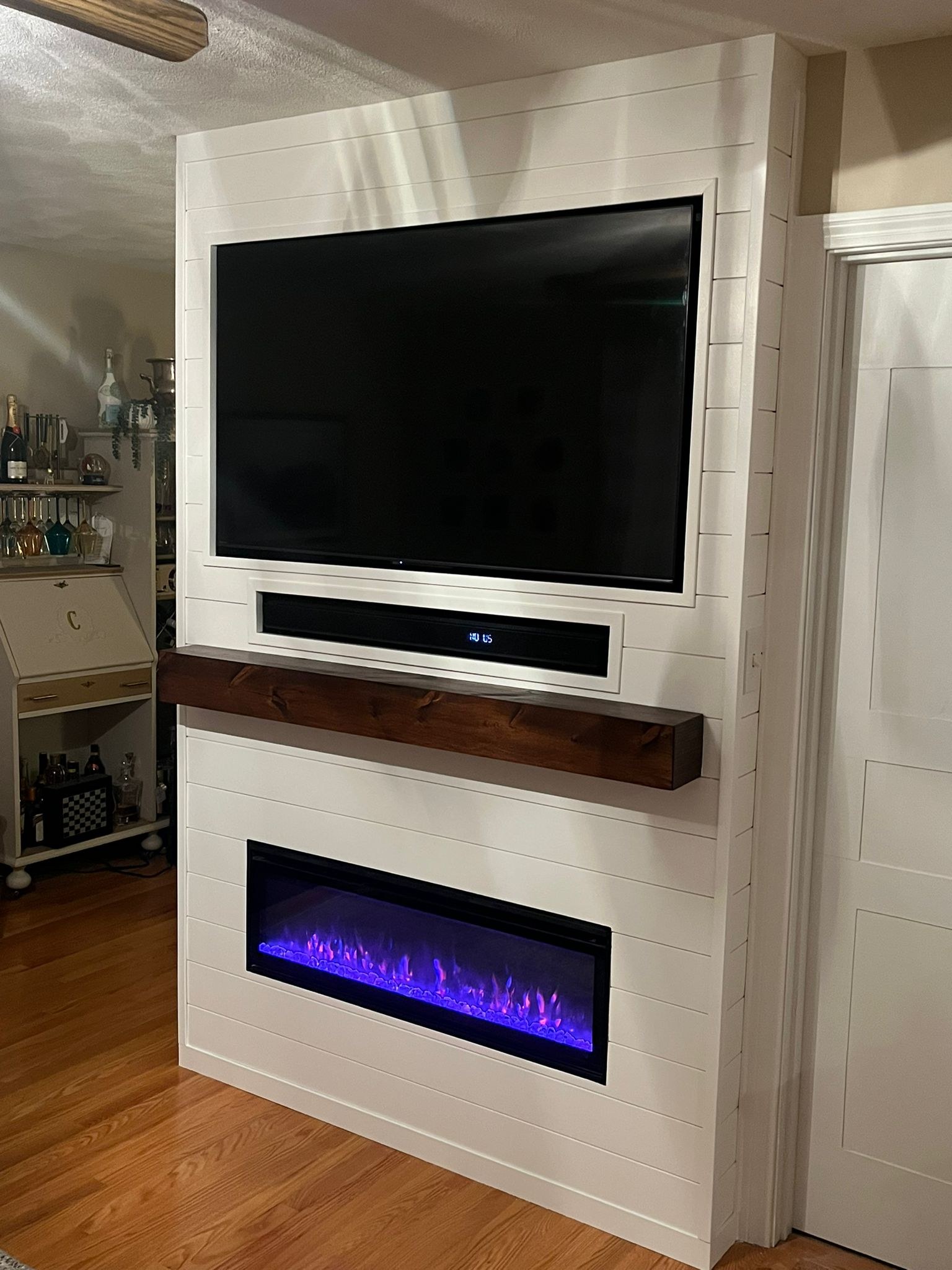 Closer, frontal view of the same shiplap fireplace wall and mantel