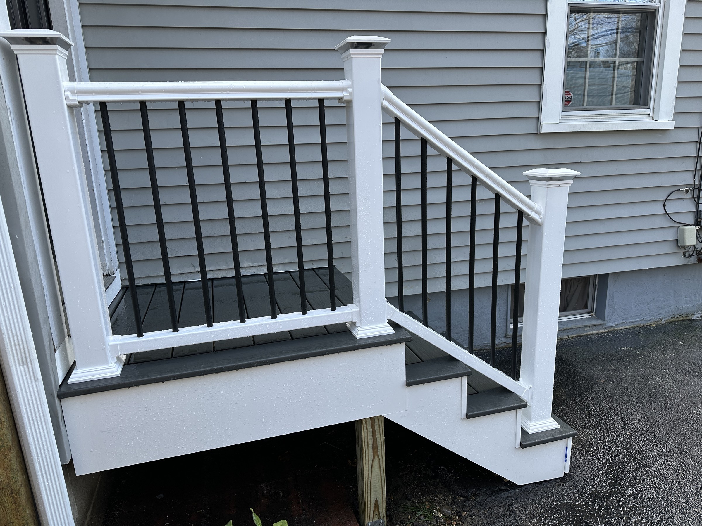 Low-angle detail of the balusters, newel post and solar-cap light at the landing turn, Reading