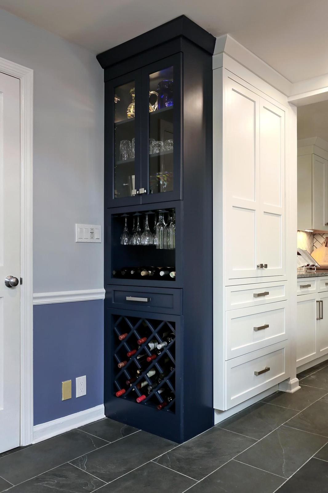 Custom navy-blue bar cabinet with a lattice wine rack and glass-front upper cabinet