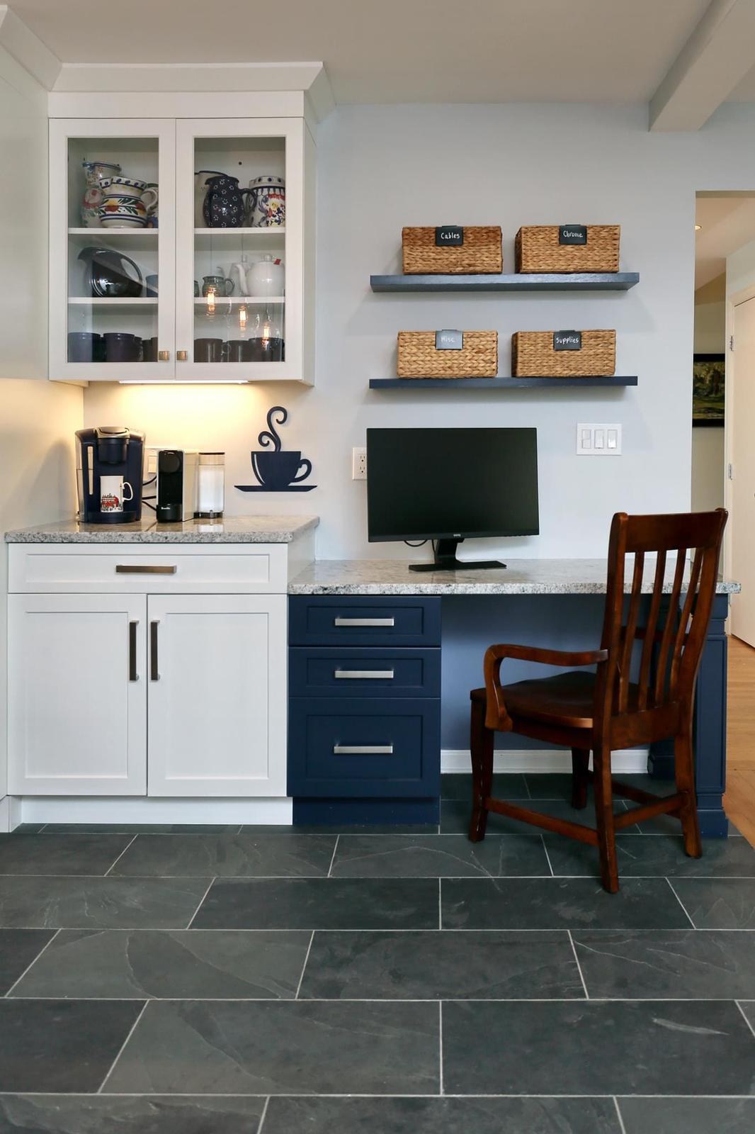 Built-in coffee and desk nook with navy lower cabinets and white glass-front upper cabinets
