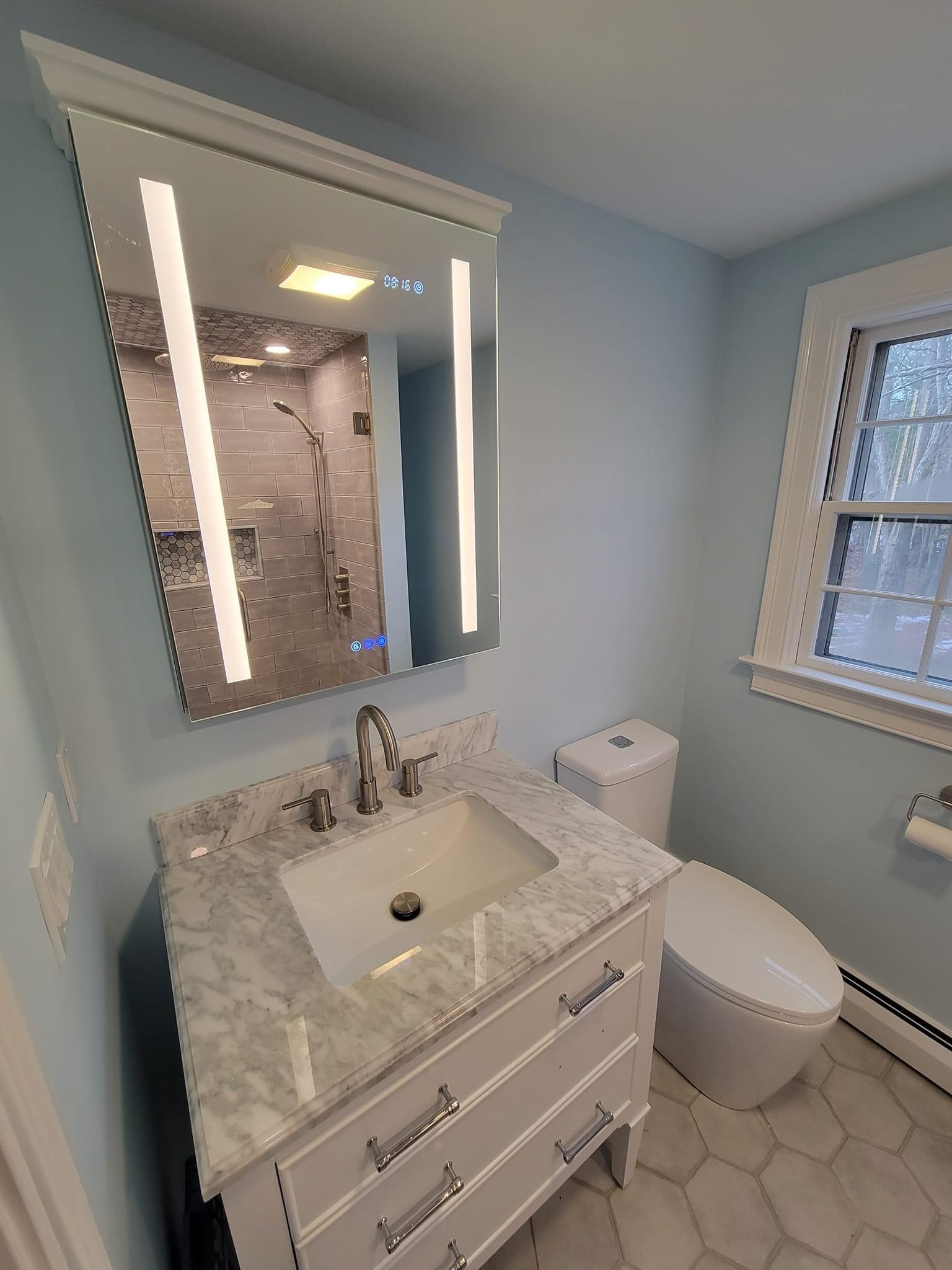 Bathroom vanity with a marble top and backlit LED mirror, Winthrop
