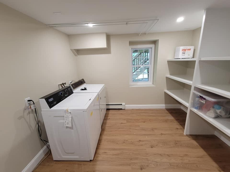 Finished basement laundry room with new built-in shelving and flooring, Lynnfield