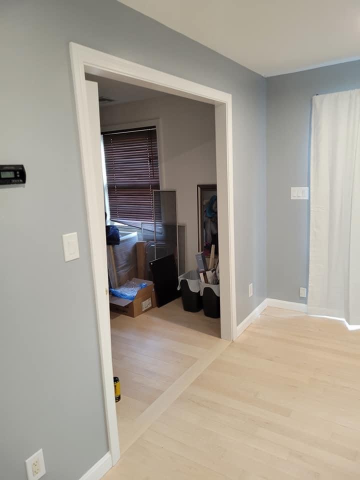 Room with a wide-plank floor inlay border detail, Melrose