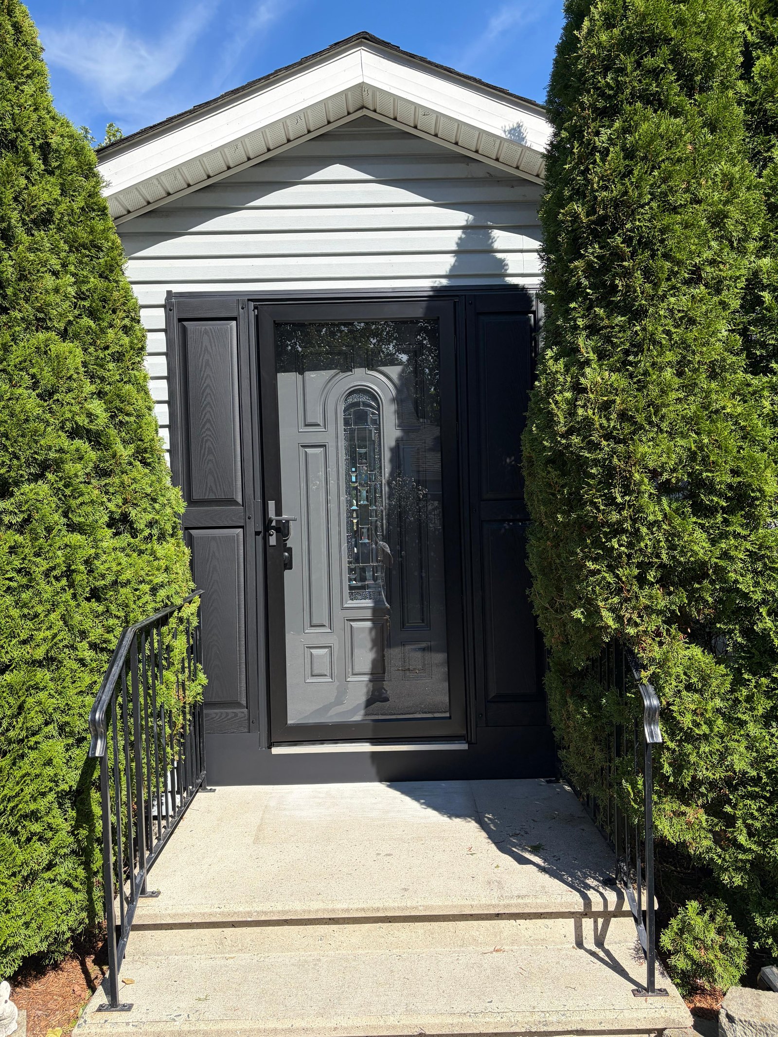 Finished black front entry with storm door and raised side panels, Peabody